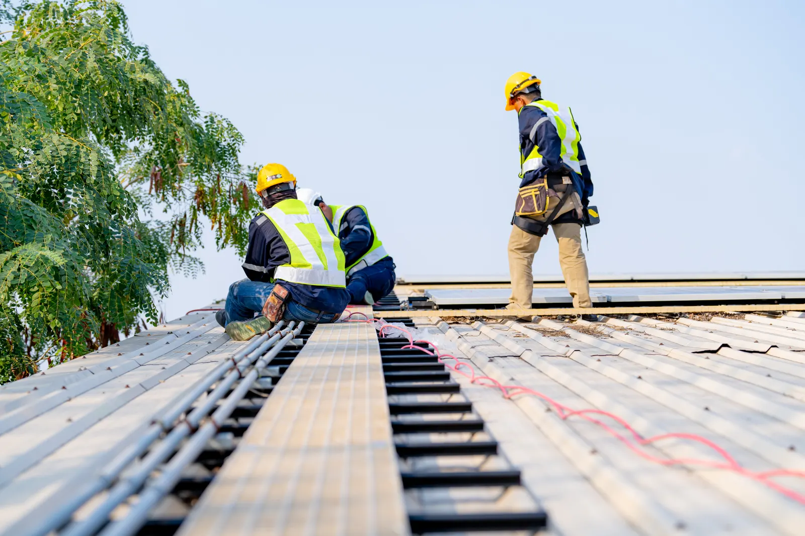 Crew installing an asphalt roof
